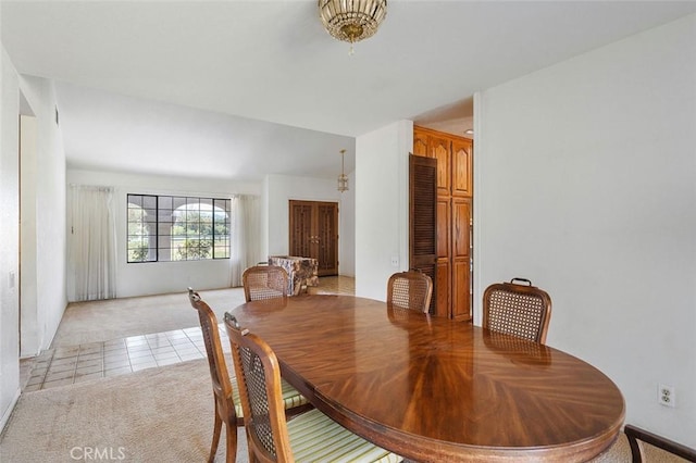 dining area with light tile patterned floors, light carpet, and baseboards