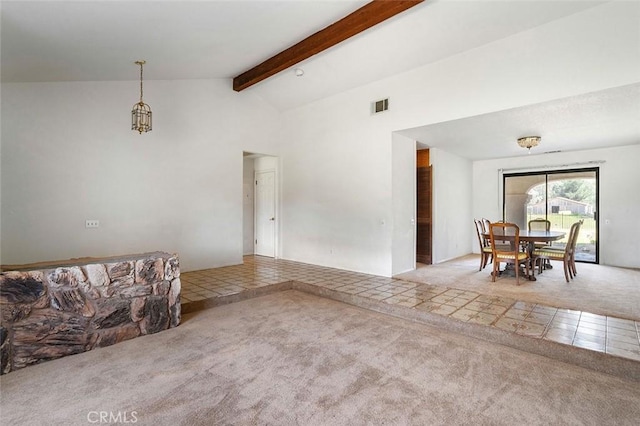 tiled living area featuring visible vents, vaulted ceiling with beams, and carpet floors