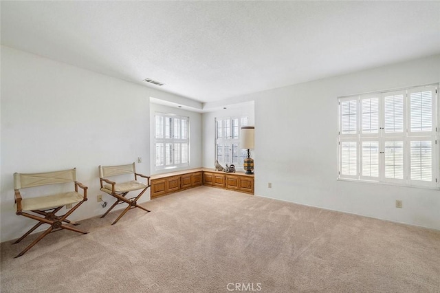 unfurnished room with visible vents and light carpet