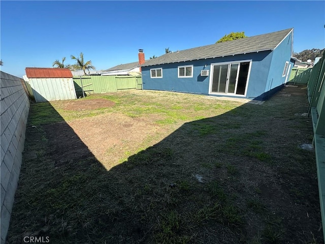 2569 Caulfield Dr, San Diego, CA 92154 - rear view of property featuring stucco siding, a fenced backyard, and a storage unit