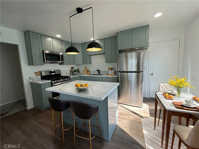 2569 Caulfield Dr, San Diego, CA 92154 - kitchen with stainless steel appliances, green cabinetry, dark wood finished floors, and recessed lighting