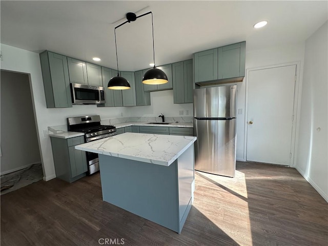 2569 Caulfield Dr, San Diego, CA 92154 - kitchen with stainless steel appliances, dark wood-type flooring, recessed lighting, decorative light fixtures, and a center island