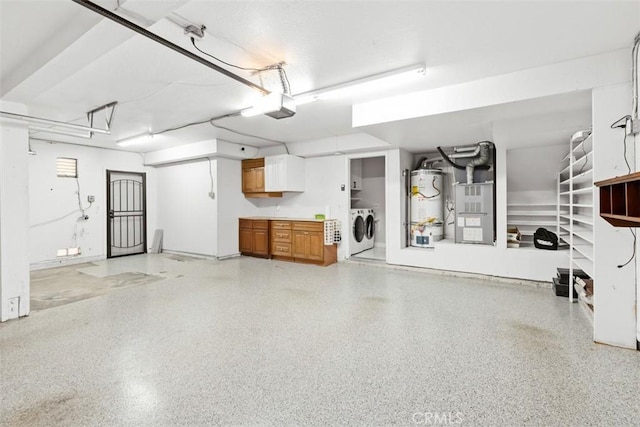 garage featuring water heater, washer and clothes dryer, a garage door opener, and heating unit