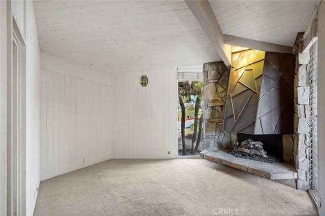 unfurnished living room with wood ceiling, carpet flooring, and beamed ceiling