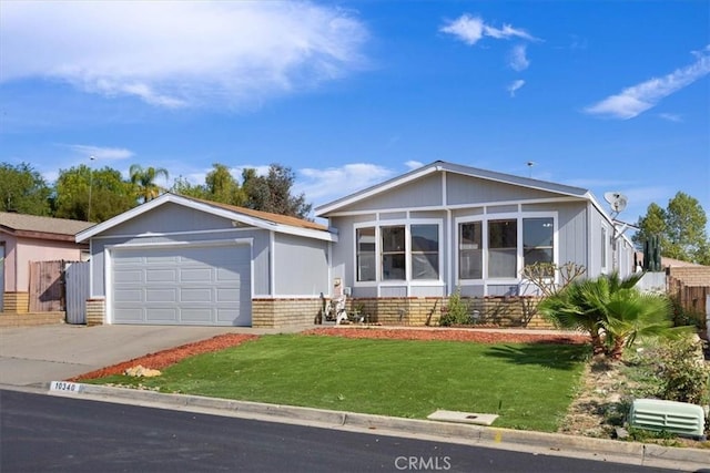view of front of home featuring concrete driveway, a garage, and a front lawn