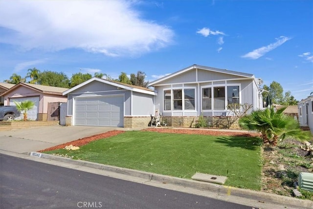 view of front facade with a front yard, driveway, and a garage