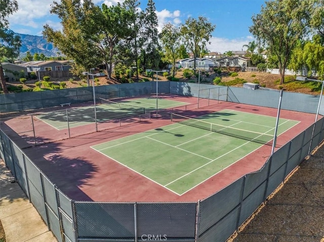 view of sport court featuring a mountain view, fence, and community basketball court