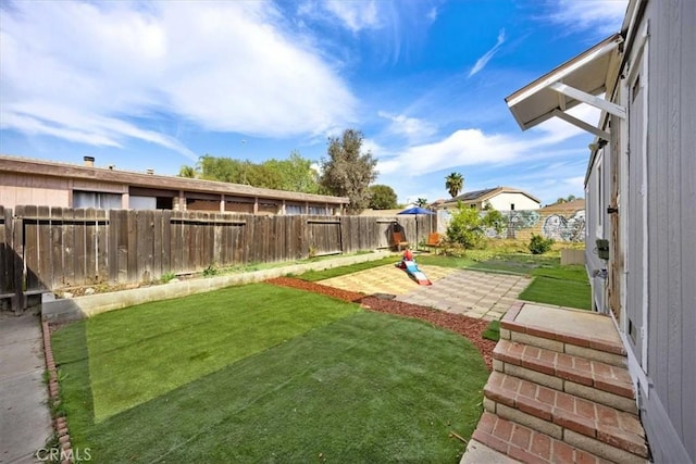 view of yard with a patio and a fenced backyard