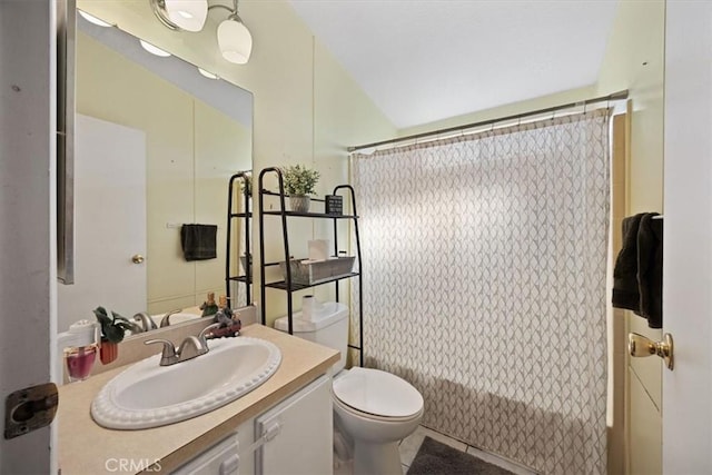 bathroom with shower / bath combo with shower curtain, vanity, and toilet