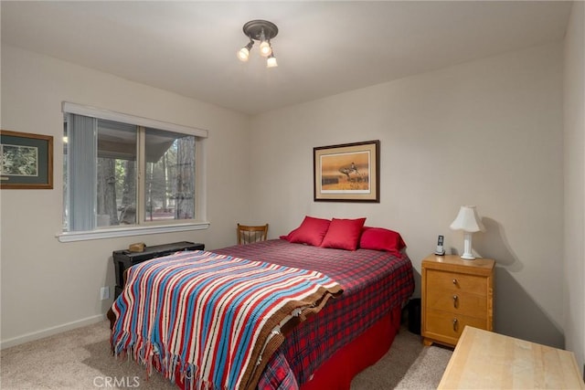 bedroom with baseboards and carpet flooring