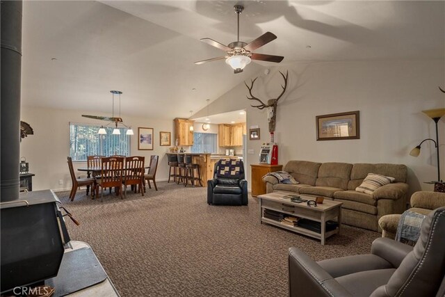 7528 Humboldt Rd, Butte Meadows, CA 95942 - living area featuring carpet, a ceiling fan, vaulted ceiling, a wood stove, and baseboards