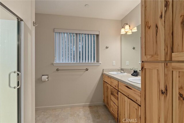 7528 Humboldt Rd, Butte Meadows, CA 95942 - bathroom featuring baseboards, a stall shower, and double vanity