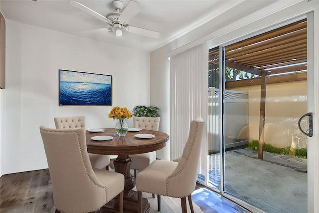 dining space with wood finished floors and a ceiling fan