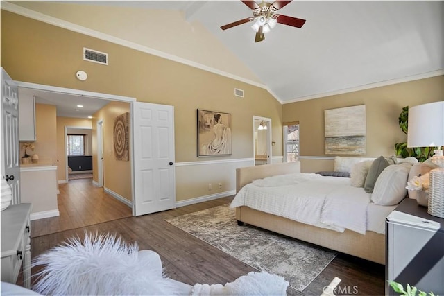 bedroom with visible vents, baseboards, high vaulted ceiling, and wood finished floors