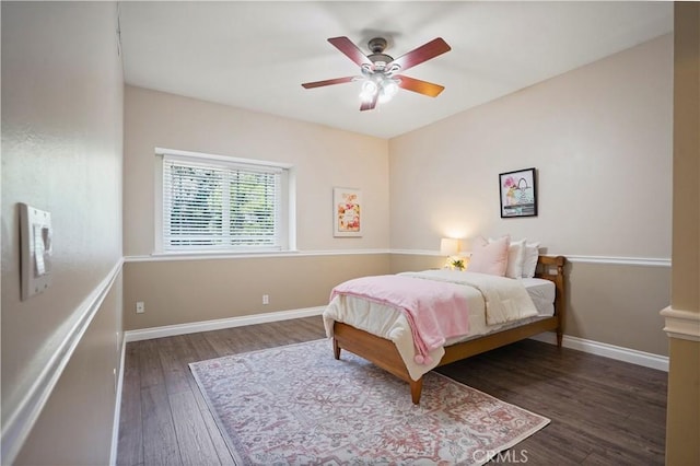 bedroom with baseboards, a ceiling fan, and wood finished floors