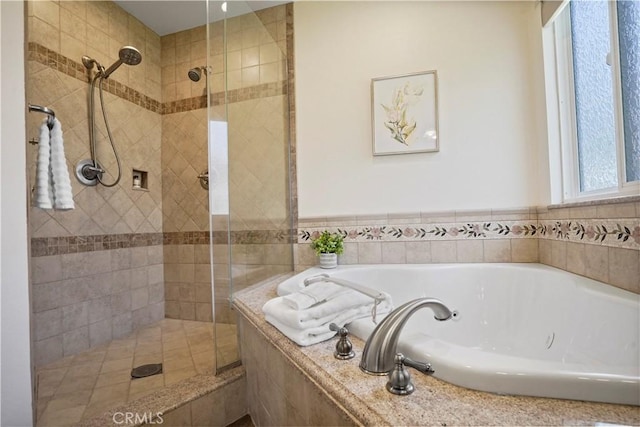 full bath with a shower stall and a garden tub