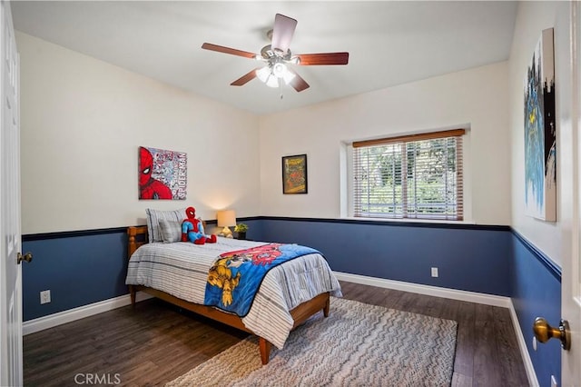 bedroom featuring wood finished floors, baseboards, and a ceiling fan