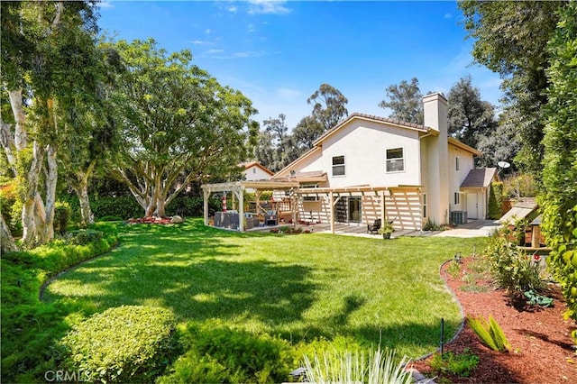 rear view of property with a patio, stucco siding, a chimney, a pergola, and a lawn