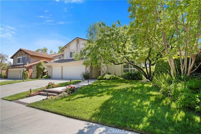 view of front of house featuring concrete driveway, stucco siding, an attached garage, a front yard, and a tile roof