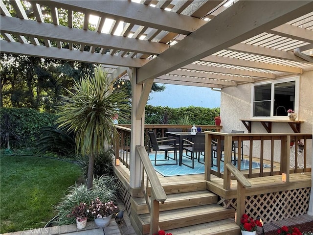 wooden terrace with outdoor dining space, a lawn, and a pergola