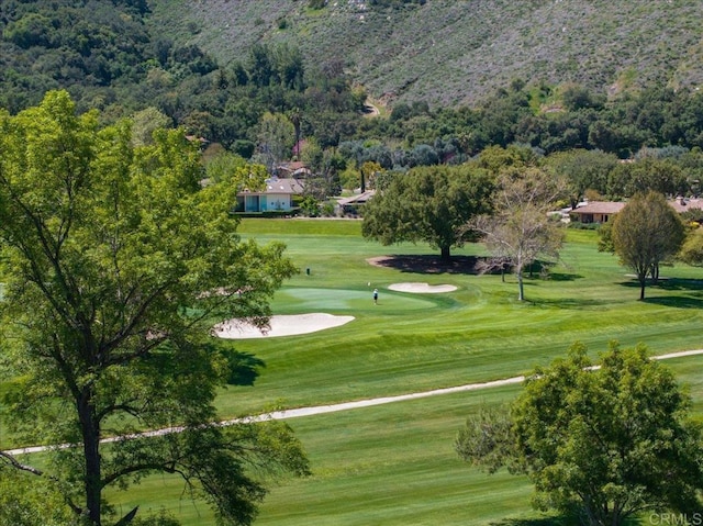 16270 Pauma Valley Dr, Pauma Valley, CA 92061 - view of property's community with view of golf course, a lawn, and a wooded view