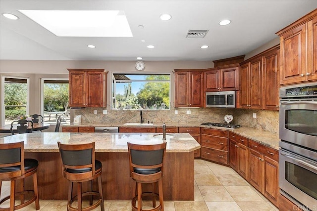 16270 Pauma Valley Dr, Pauma Valley, CA 92061 - kitchen featuring stainless steel appliances, healthy amount of natural light, a skylight, backsplash, and recessed lighting