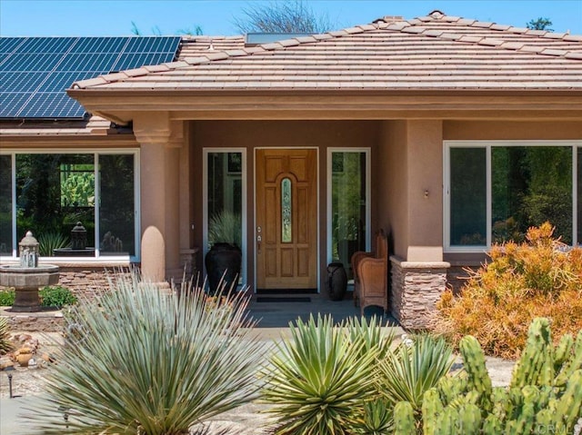 16270 Pauma Valley Dr, Pauma Valley, CA 92061 - entrance to property with stucco siding, solar panels, a tiled roof, and stone siding