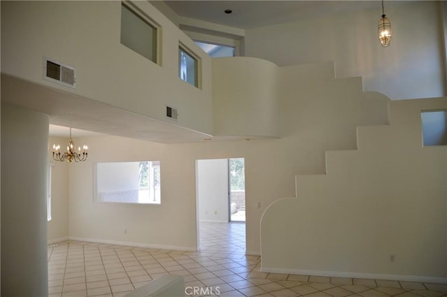24391 Rue De Gauguin, Laguna Niguel, CA 92677 - spare room with light tile patterned flooring, stairway, a high ceiling, and a chandelier