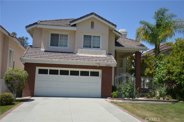 24391 Rue De Gauguin, Laguna Niguel, CA 92677 - traditional home featuring a garage, driveway, brick siding, a tile roof, and stucco siding