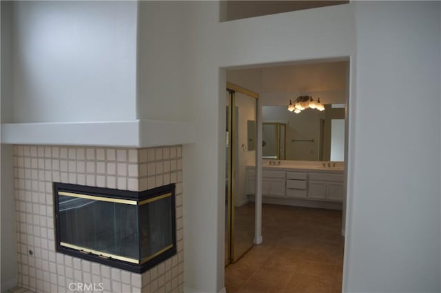 24391 Rue De Gauguin, Laguna Niguel, CA 92677 - interior space with a multi sided fireplace, tile patterned flooring, and vanity