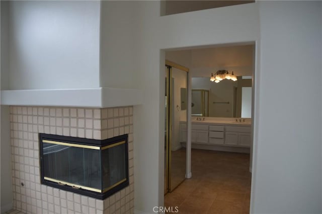 24391 Rue De Gauguin, Laguna Niguel, CA 92677 - bathroom featuring a multi sided fireplace, double vanity, and tile patterned floors