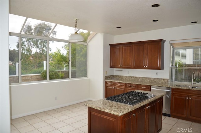 24391 Rue De Gauguin, Laguna Niguel, CA 92677 - kitchen with appliances with stainless steel finishes, light tile patterned flooring, light stone counters, a center island, and pendant lighting