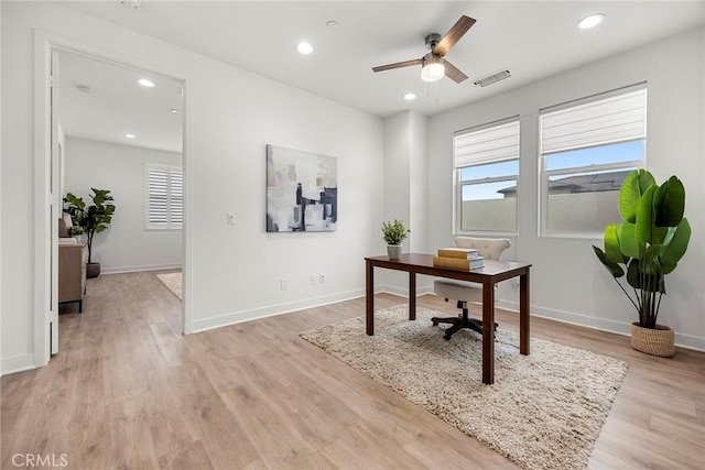 home office featuring ceiling fan, visible vents, a healthy amount of sunlight, and light wood-style floors