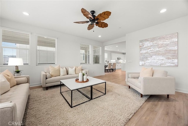 living room featuring recessed lighting, ceiling fan, a wealth of natural light, and light wood-style flooring