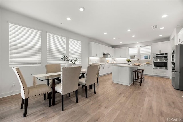 dining space featuring visible vents, recessed lighting, and light wood-style floors