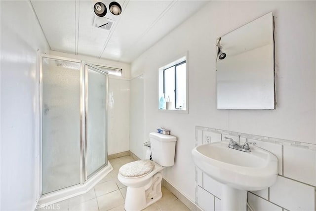 bathroom with visible vents, toilet, tile patterned floors, and a shower stall