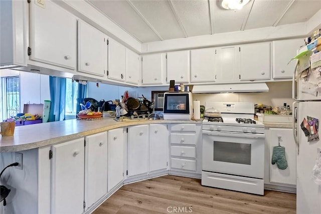 kitchen featuring light countertops, light wood-style flooring, under cabinet range hood, white appliances, and white cabinets