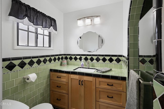 1441 Cleveland Rd, Glendale, CA 91202 - full bathroom featuring toilet, vanity, a wainscoted wall, and tile walls