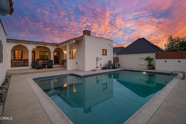 1441 Cleveland Rd, Glendale, CA 91202 - pool at dusk with fence, ceiling fan, a patio area, and a fenced in pool