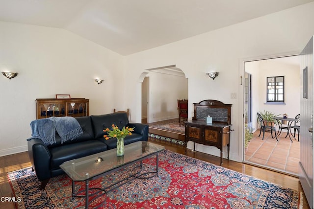 1441 Cleveland Rd, Glendale, CA 91202 - living area with arched walkways, baseboards, lofted ceiling, and wood finished floors