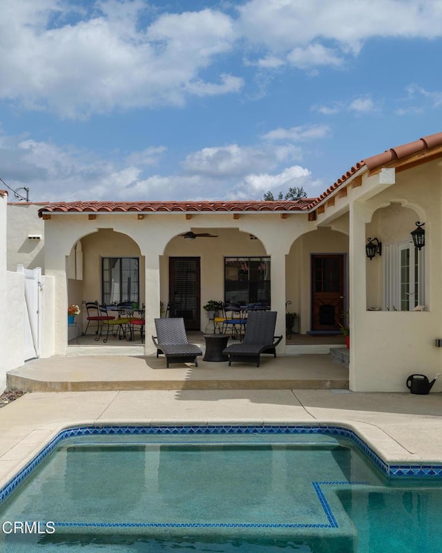 1441 Cleveland Rd, Glendale, CA 91202 - rear view of property with stucco siding, a tiled roof, a patio, an outdoor pool, and ceiling fan