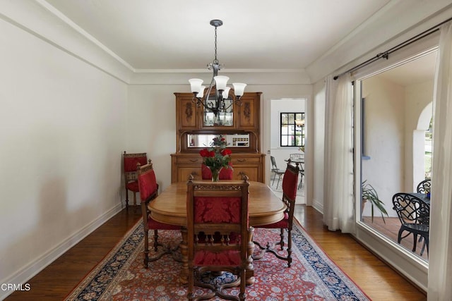 1441 Cleveland Rd, Glendale, CA 91202 - dining space featuring baseboards, ornamental molding, wood finished floors, and an inviting chandelier