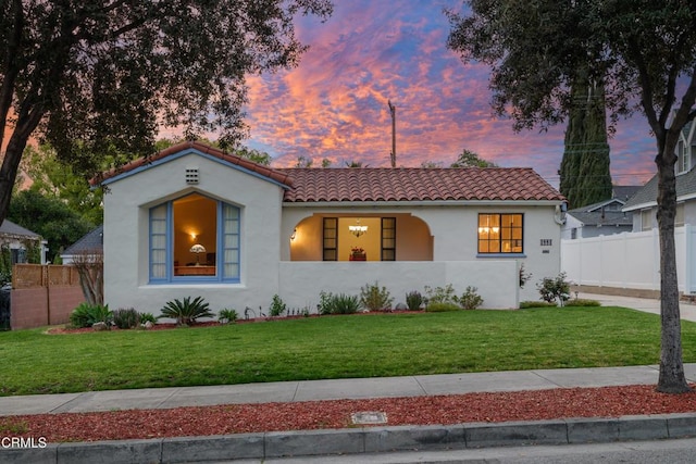 1441 Cleveland Rd, Glendale, CA 91202 - mediterranean / spanish-style home featuring stucco siding, a tile roof, fence, and a lawn