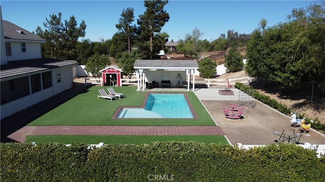 41559 Floyd Ct, Temecula, CA 92592 - outdoor pool featuring a patio area, an outbuilding, and a lawn