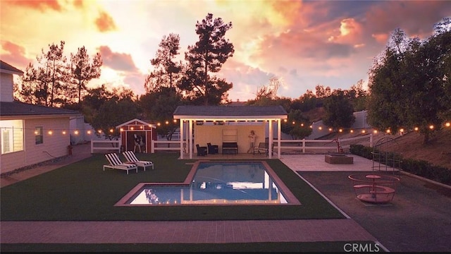 41559 Floyd Ct, Temecula, CA 92592 - view of pool featuring a fire pit, a fenced backyard, a patio area, an outdoor structure, and a gazebo