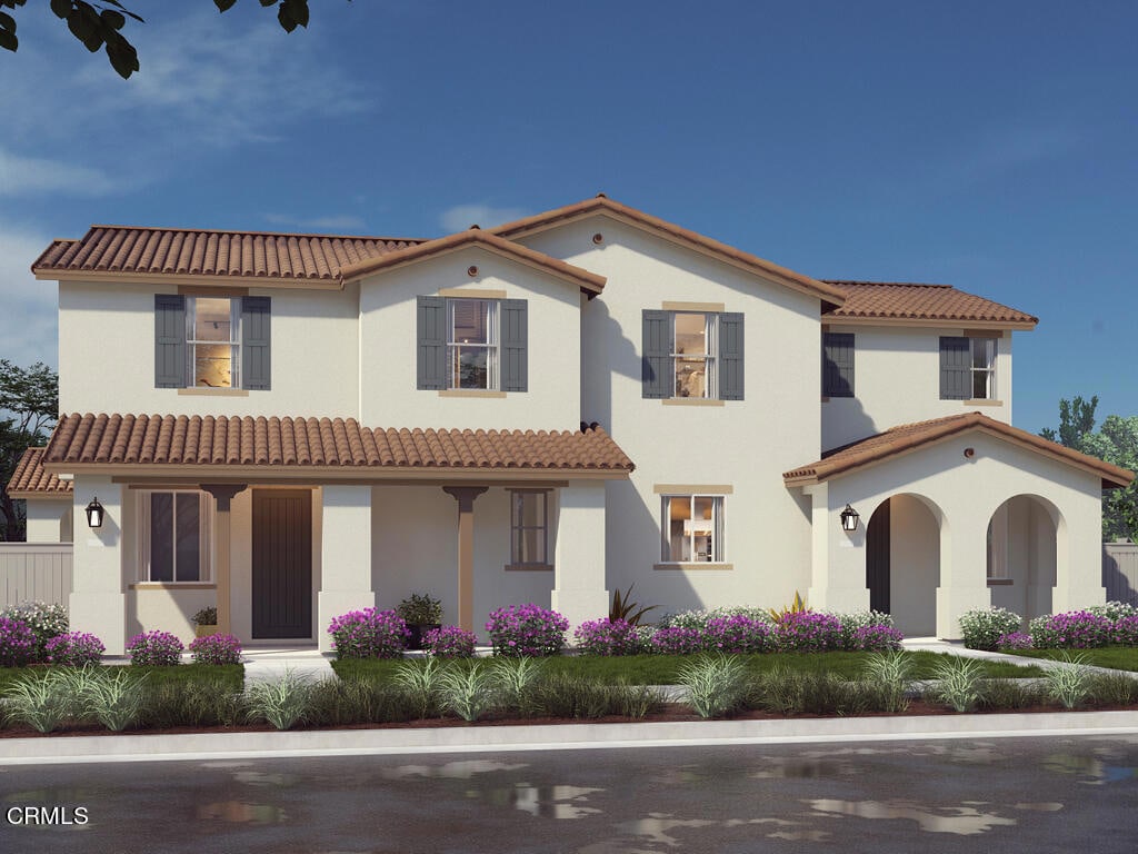 mediterranean / spanish home with a tile roof and stucco siding