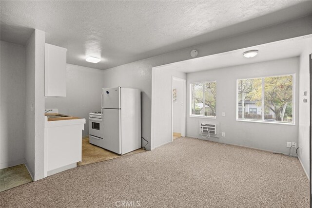 282 E 8th St, Chico, CA 95928 - kitchen featuring heating unit, light carpet, white appliances, a textured ceiling, and white cabinetry