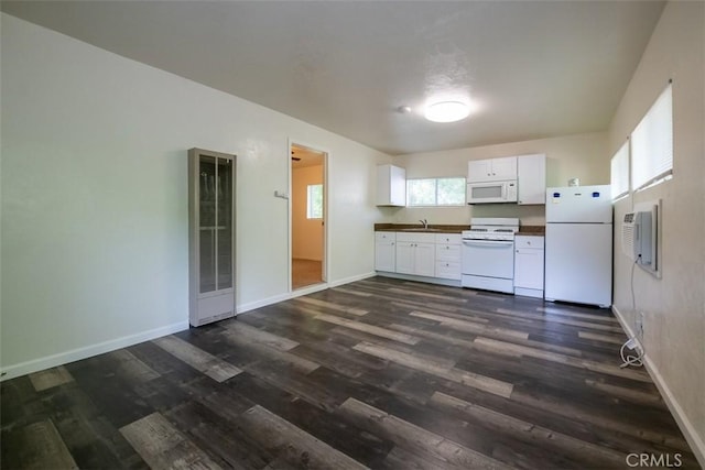 282 E 8th St, Chico, CA 95928 - kitchen featuring dark wood-style flooring, dark countertops, white cabinets, white appliances, and a heating unit