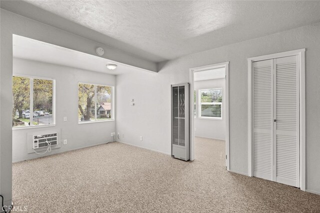 282 E 8th St, Chico, CA 95928 - unfurnished bedroom with carpet floors, a wall unit AC, a textured ceiling, and a heating unit