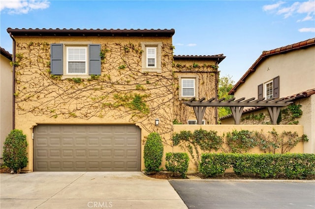 view of front of home featuring a pergola, stucco siding, a garage, and concrete driveway